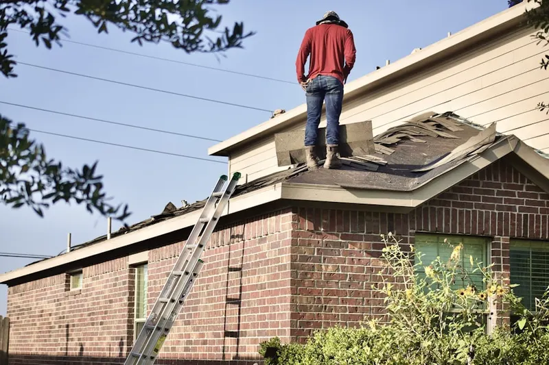 Professional roofer working on a residential roof in Villas North